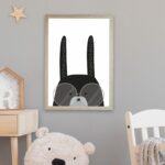 A black bunny illustrated print hanging in a nursery