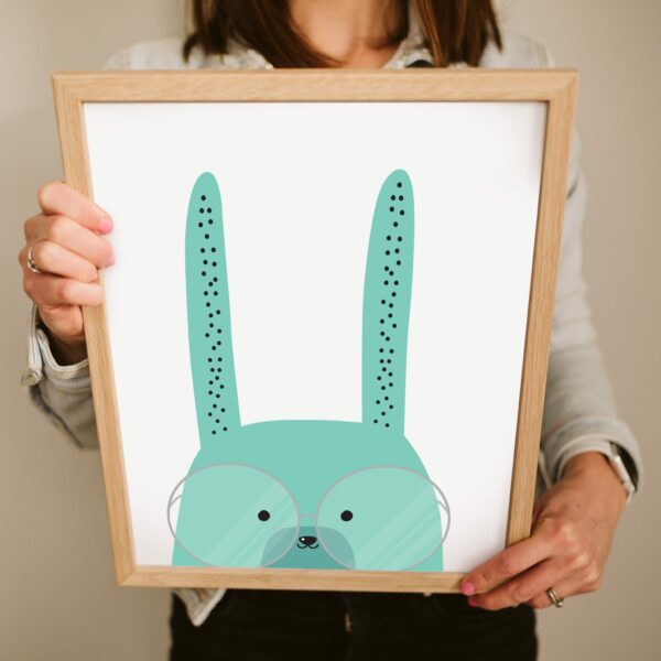 A green bunny illustration printed and framed for decoration in a baby boy or girls bedroom